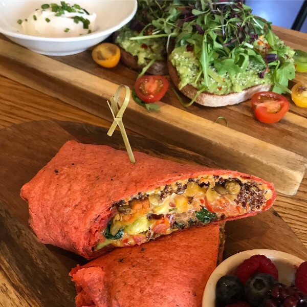 Proprietor's vegan breakfast burrito with mixed berries on the side.